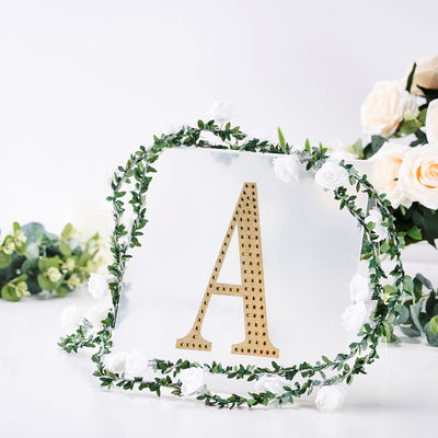 Gold letter "A" displayed with floral decoration on a clear background.