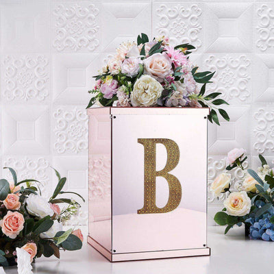 Decorative flower box with letter B and floral arrangement on a textured background.