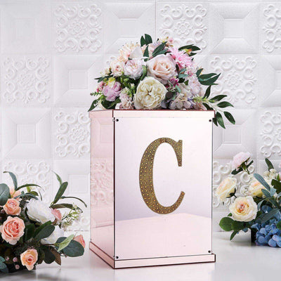 Elegant pink flower box with floral arrangement and gold initial "C".