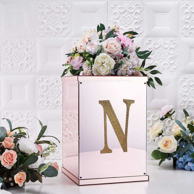 Personalized mirrored flower box with gold letter N and floral arrangement.