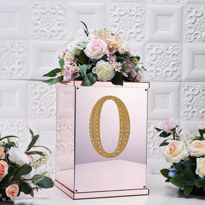 Mirrored box with floral arrangement and gold number "0" decoration.
