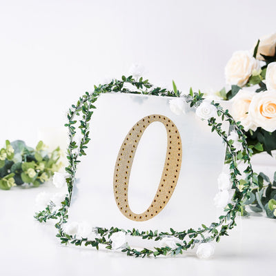 Golden number zero decor with floral wreath on a clear background.