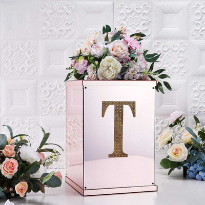 Mirrored wedding gift box with floral arrangement and letter 'T' decoration.