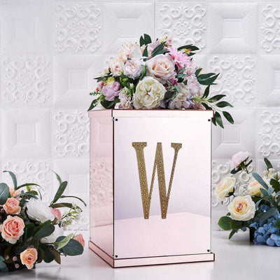 Rose gold floral display box with initial "W" and decorative flowers.