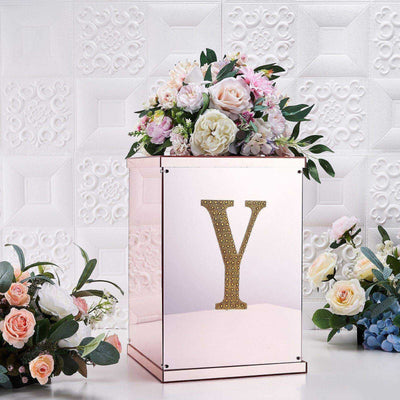 Decorative flower box with gold letter "Y" and floral arrangement.