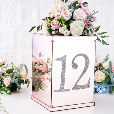 Decorative flower arrangement atop a mirrored box with the number 12.