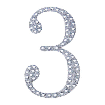 Silver glitter number three cutout on a white background.