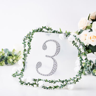 Table number 3 with rhinestones and floral garland decoration