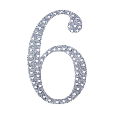 Glittery silver number six decoration on a white background