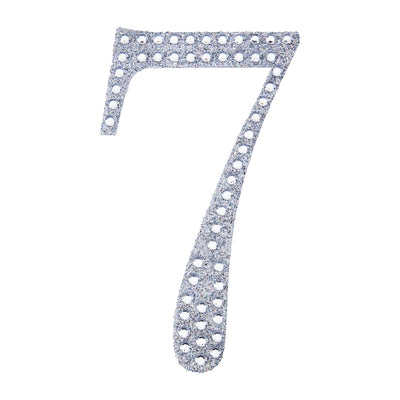 Glittery silver number 7 cutout on a plain background