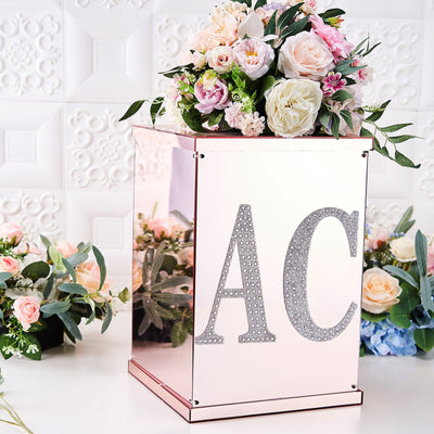 Mirrored floral display box with "AC" decoration and assorted flowers