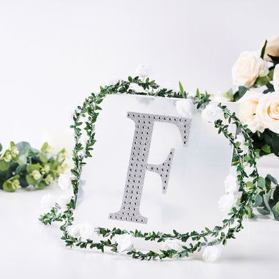 Decorative acrylic letter "F" with floral wreath accents