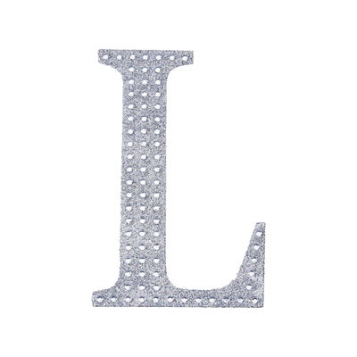 Silver rhinestone letter "L" decoration on a white background.
