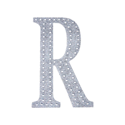 Silver glitter letter "R" cutout on white background