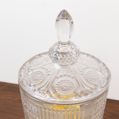 Decorative glass jar with lid and intricate patterns