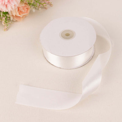 White satin ribbon spool with cut ribbon end