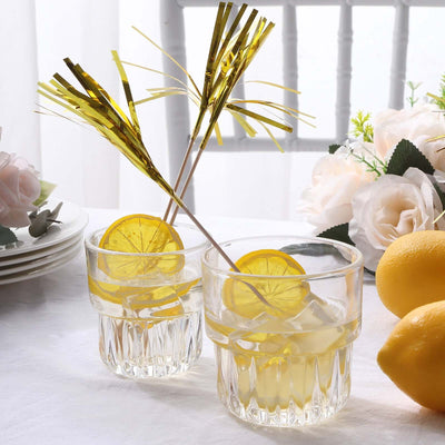 Two glasses of lemonade with lemon slices and festive decorations on a table.