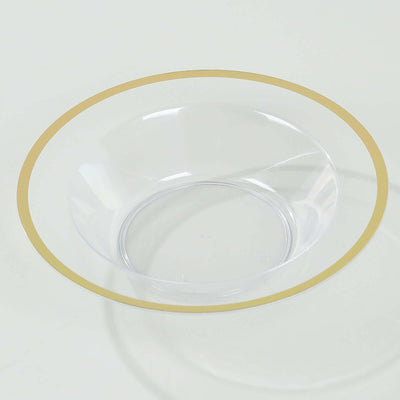 Clear glass bowl with a gold rim on a white background.