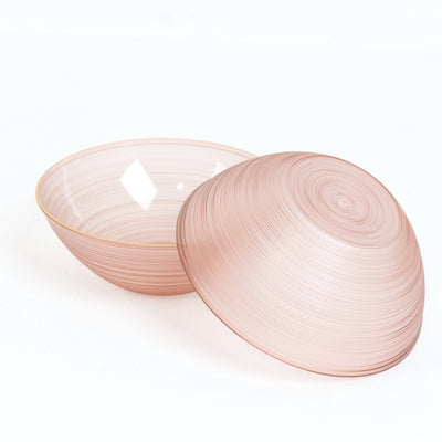 Pink decorative bowl with lid, featuring a swirling design.