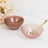 Elegant pink ceramic bowls with gold rim, perfect for serving.