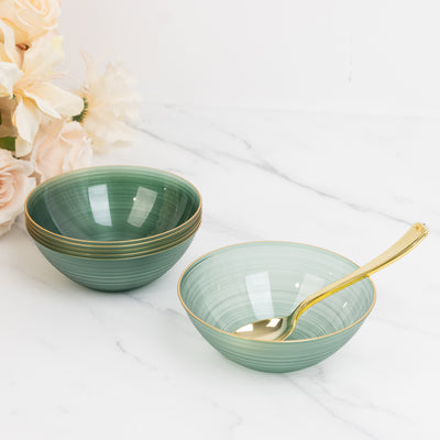 Set of elegant green bowls with gold rims and a matching spoon.