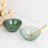 Set of elegant green bowls with gold rims and a matching spoon.