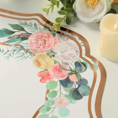 Floral decorative paper with gold accents and candle on a table.