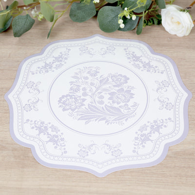 Decorative floral placemat with intricate design and scalloped edges.