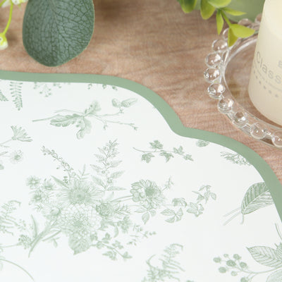 Floral-printed placemat with green accents on a textured surface.