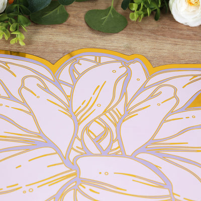 Pink floral design on a wooden surface with greenery accents.