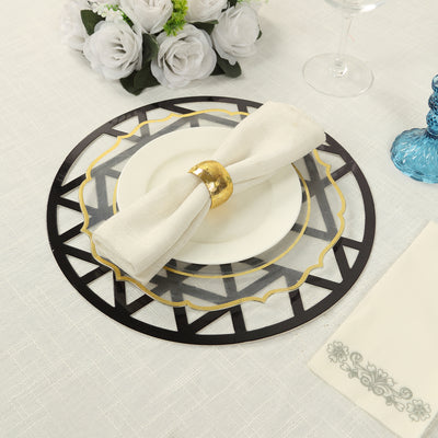 Elegant table setting with black and gold charger plate, white dish, and napkin.
