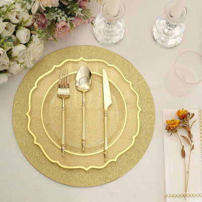 Gold-plated cutlery and decorative plate set on a dining table with floral accents.