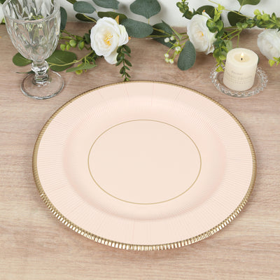 Elegant pink plate with gold rim on a wooden table with floral accents.