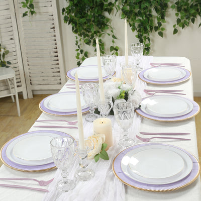 Elegant table setting with white plates, crystal glassware, and floral accents.