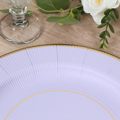Purple paper plate with gold rim and textured surface on a table setting.