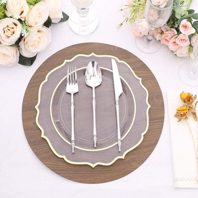 Elegant table setting with silverware on a decorative charger plate.