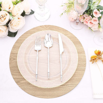 Elegant table setting with silver cutlery and floral arrangements.