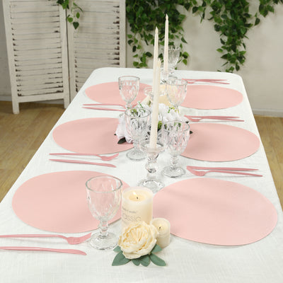 Elegant pink table settings with candles and flowers for a sophisticated dining experience.