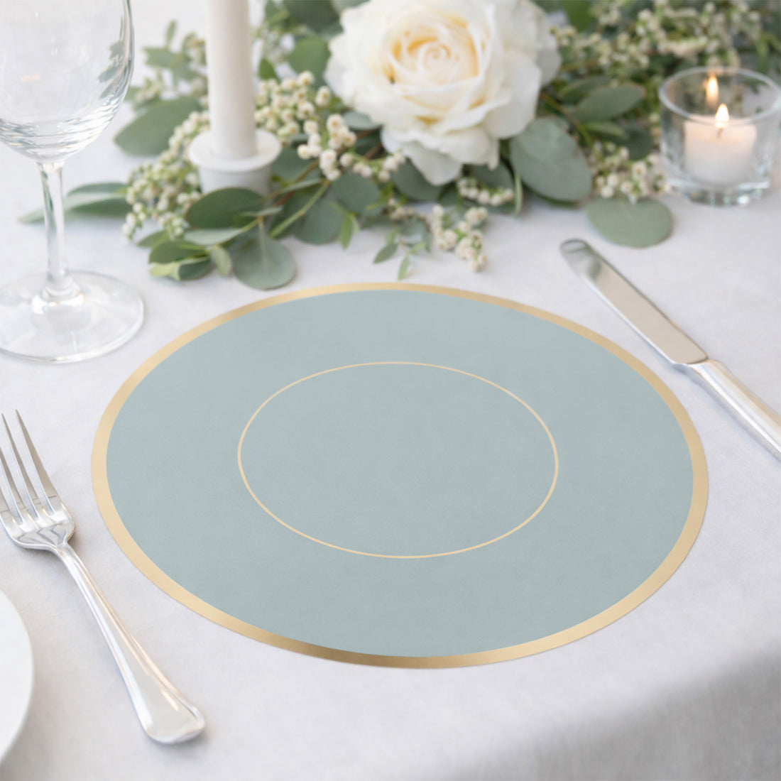 Elegant blue placemat with gold accent on a beautifully set dining table.