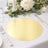 Gold round table placemat on a beautifully set dining table with floral decor.