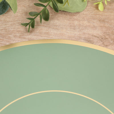 Green decorative plate with gold rim on a textured surface.