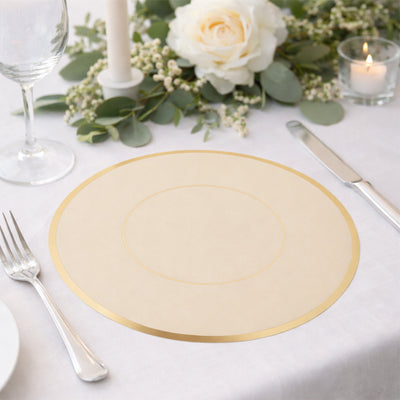 Elegant round table placemat with gold trim on a beautifully set dining table.