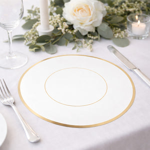 Elegant white plate with gold rim on a beautifully set table.