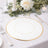 Elegant white plate with gold rim on a beautifully set table.