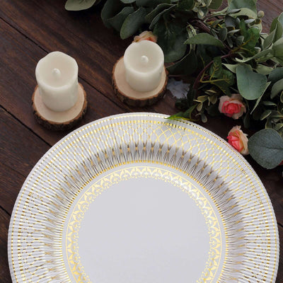 Elegant decorative plate with gold detailing, surrounded by candles and foliage.