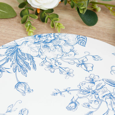 Blue floral patterned plate on a wooden table with greenery.