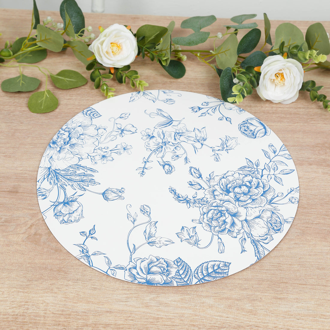 Floral decorative plate with blue designs on a white background.
