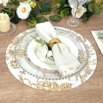 Elegant floral dinner plate set with napkin and decor elements.