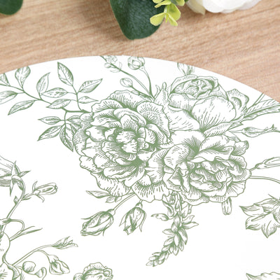 Floral design plate on wooden surface with greenery
