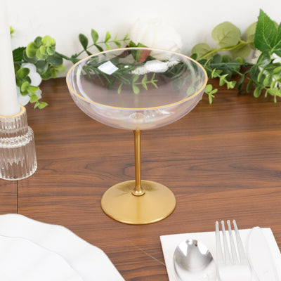 Elegant gold-rimmed glass dessert bowl on a wooden table.